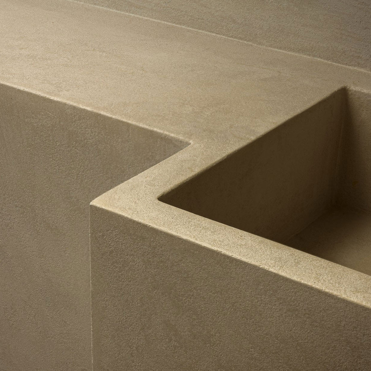Close-up of a textured beige concrete surface with geometric design