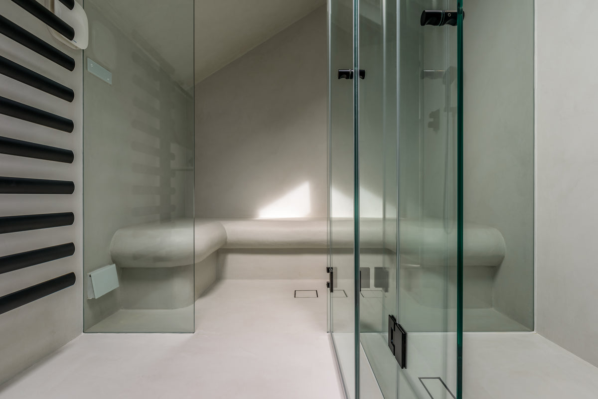 Modern bathroom with glass shower enclosure and white walls