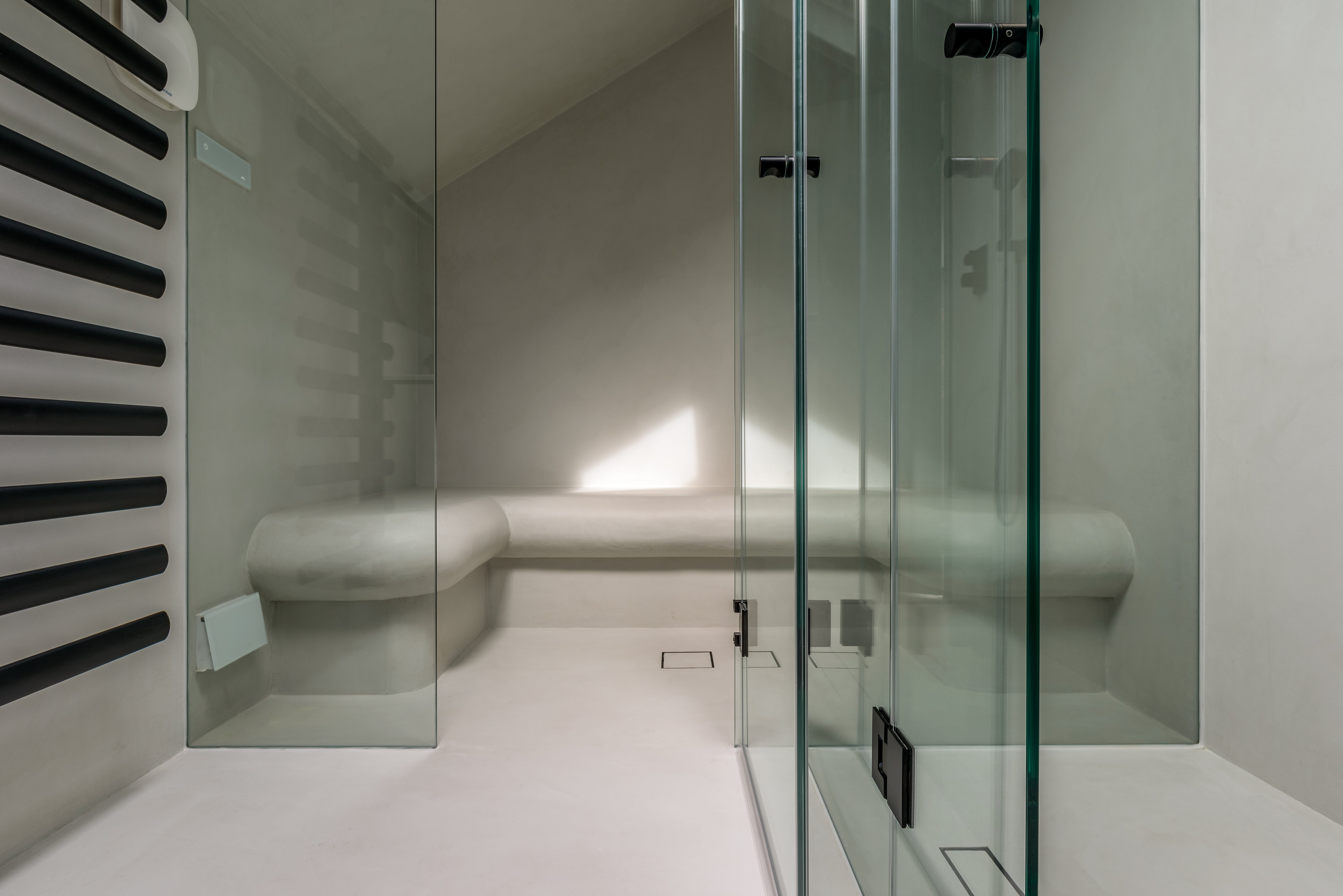 Modern bathroom with glass shower enclosure and white walls